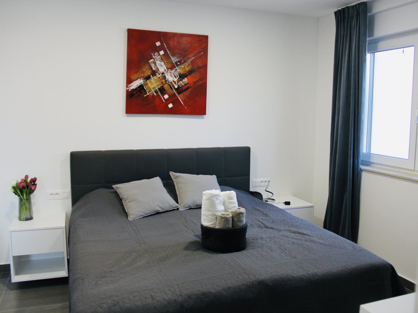 A bedroom made up, with fresh towels on the bed