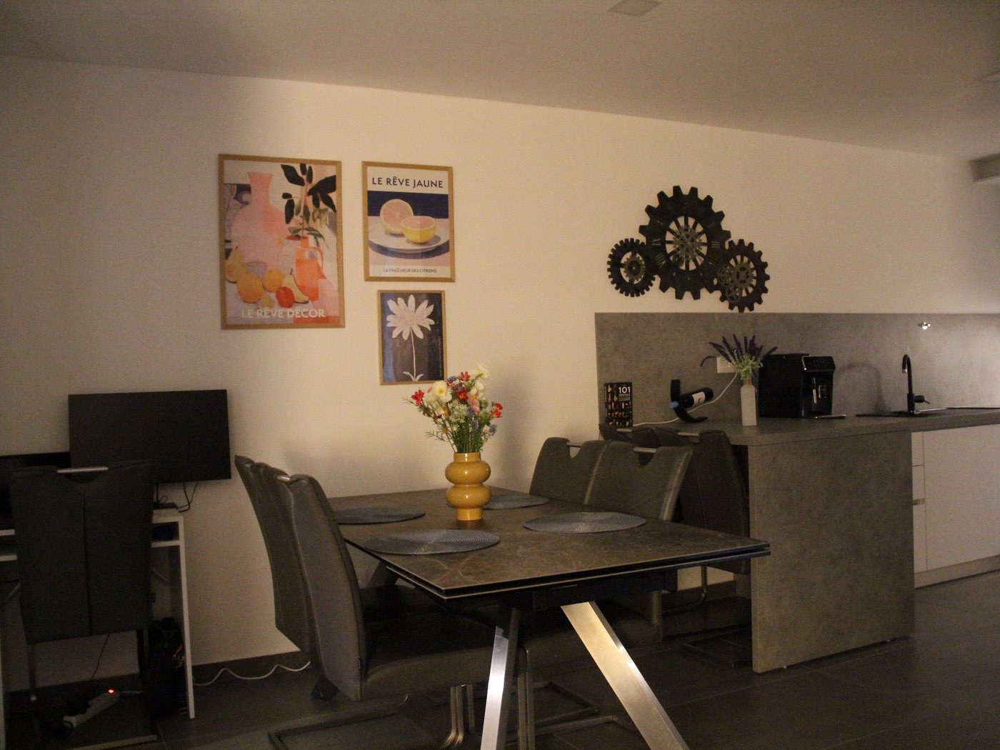 The dining table with the open kitchen behind it
