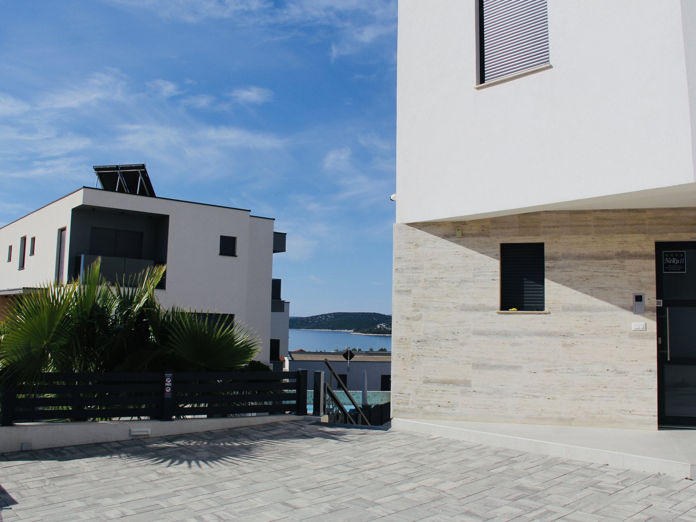 Villa NeRu from the street, with the sea beyond
