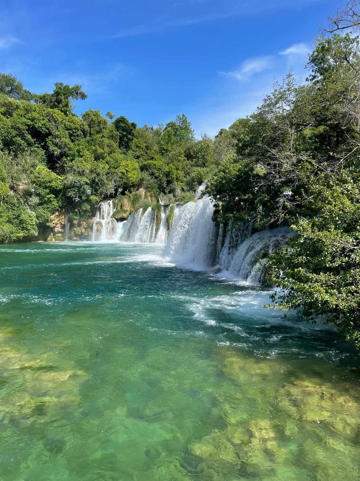 Waterfalls spilling into the turquoise pool at Krka