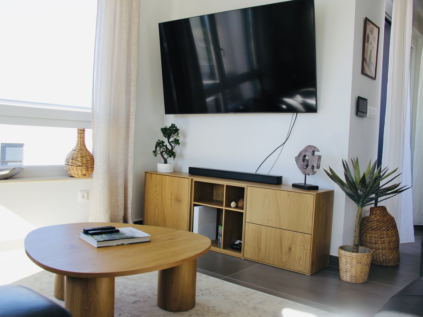 The living room with the television wall and seating area