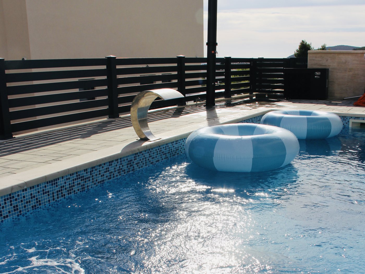 The pool and the covered terrace, with the hills behind Vodice beyond