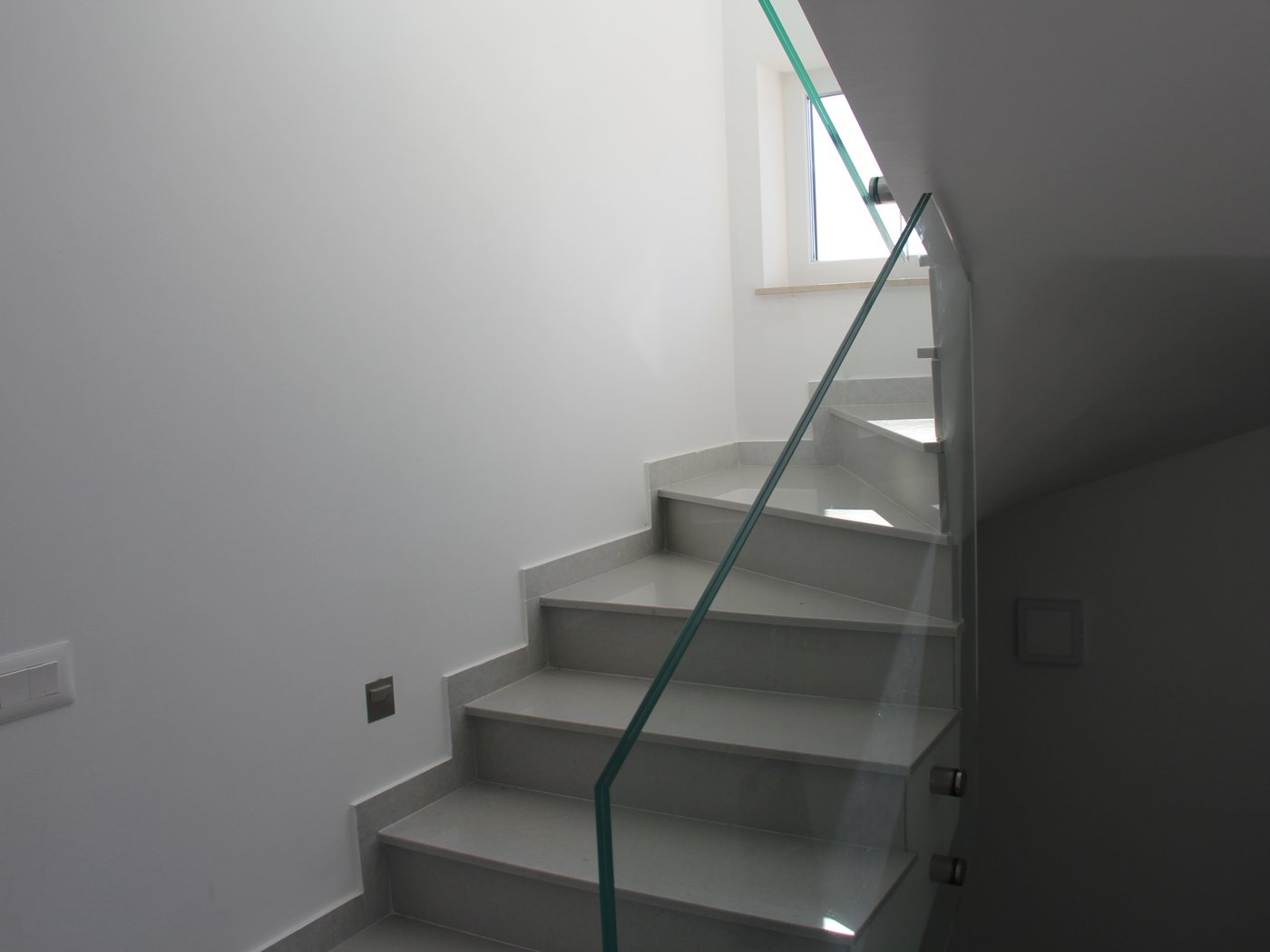 The glass-railed staircase between the floors