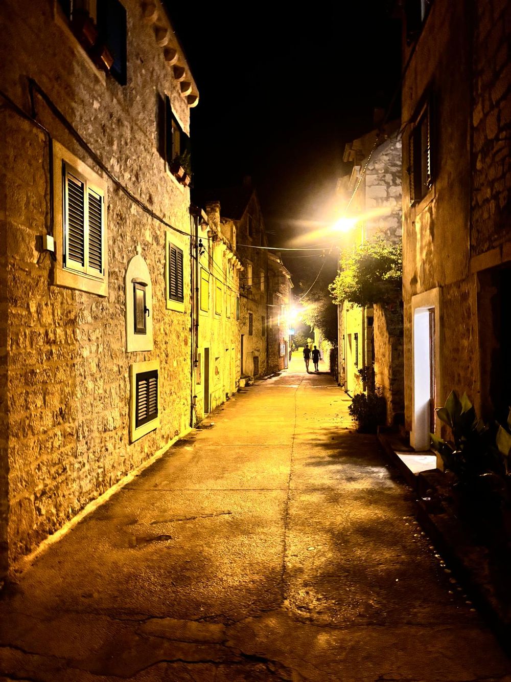 A stone alley in the old town, lit at night
